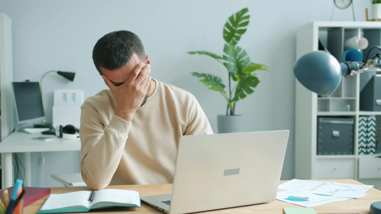 Person stressed at desk after discovering identity theft