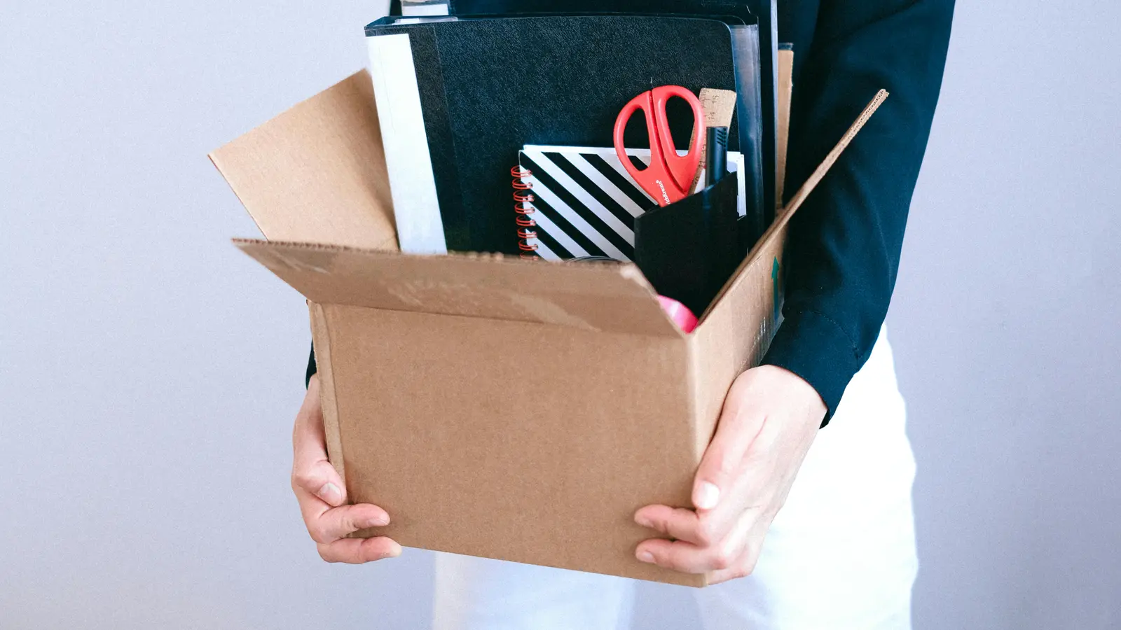 Person with box representing unemployment denial appeal