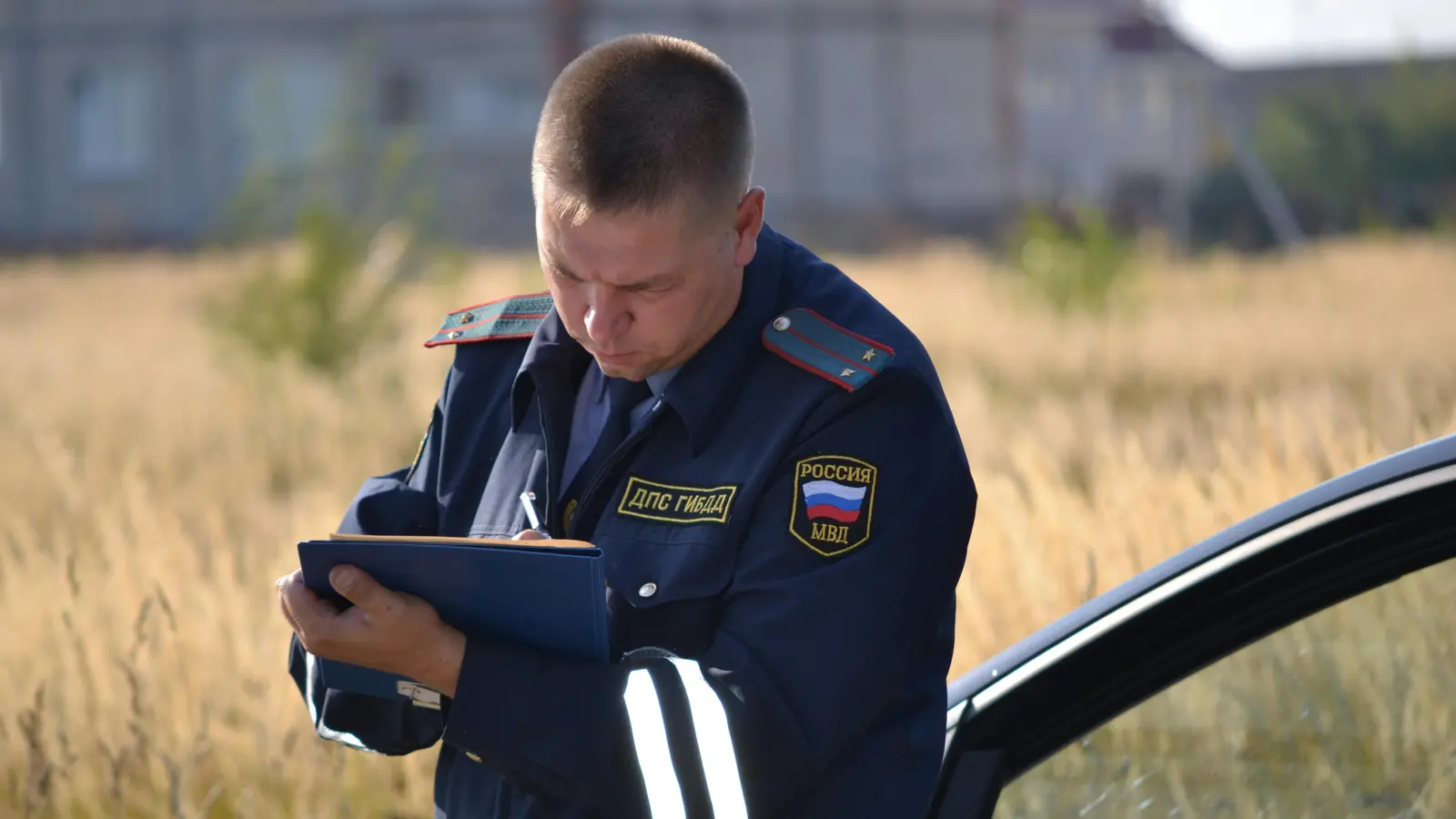 Police officer writing traffic ticket