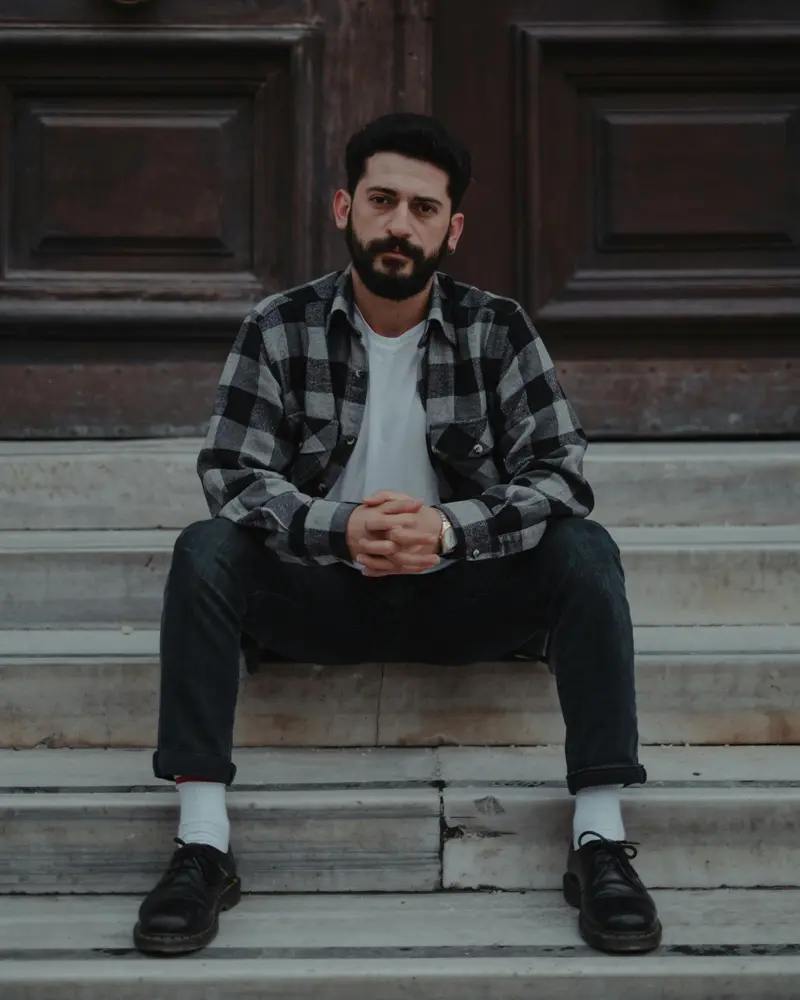 Tenant sitting on steps reading about Section 21 rights