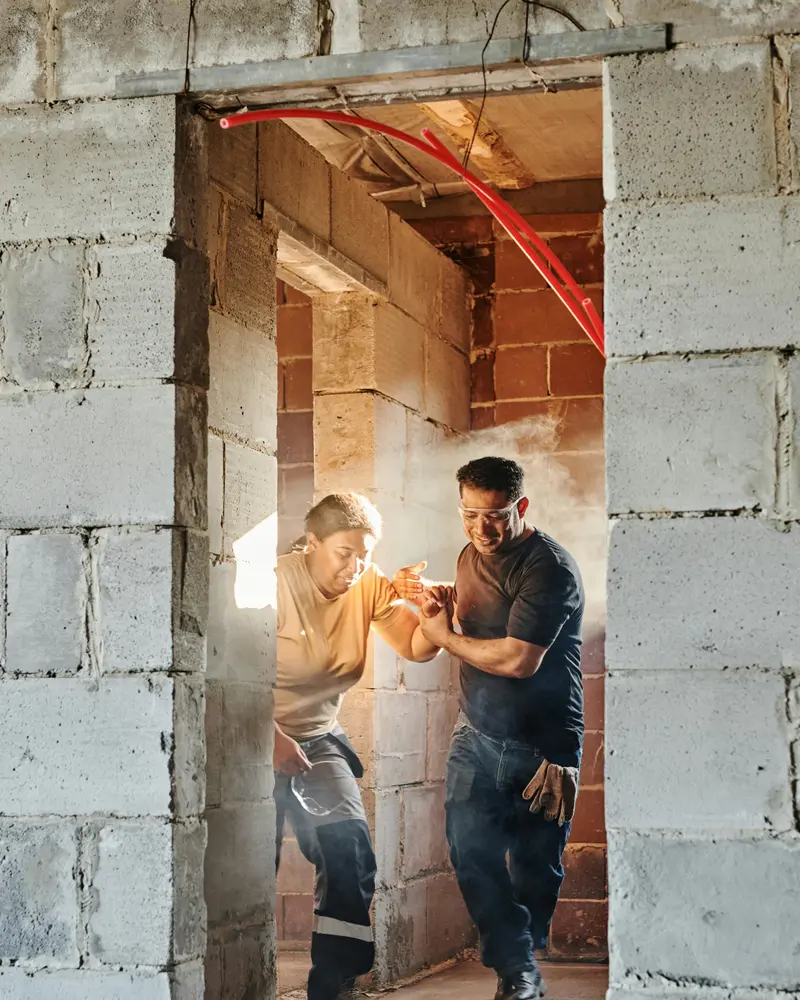 Construction workers assisting an injured colleague