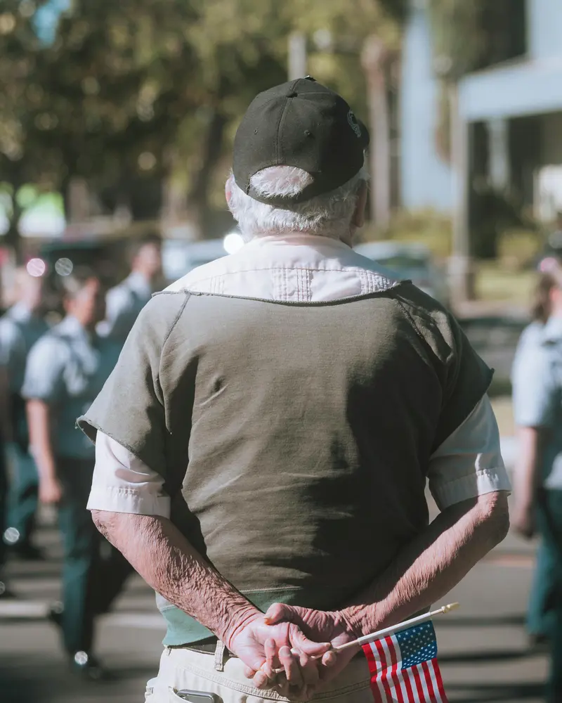 Elderly veteran holding American flag