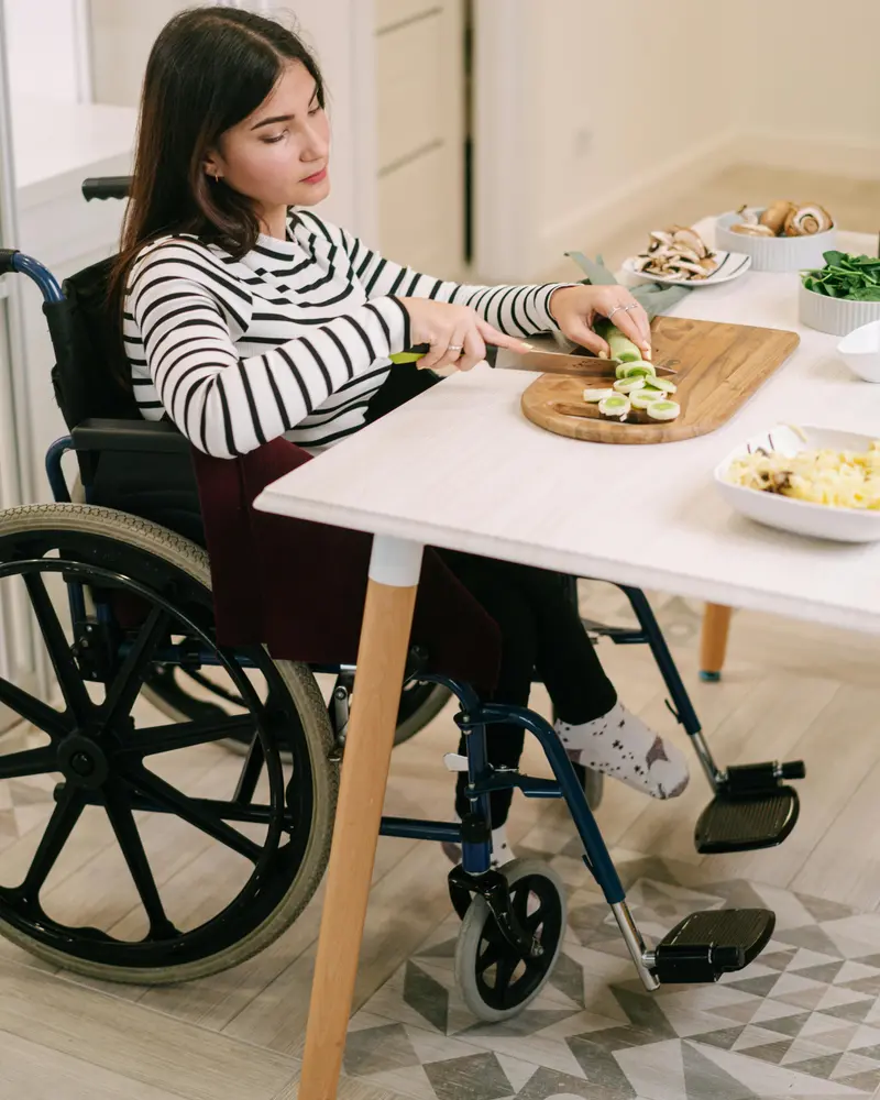 Young person with disability reviewing benefit application documents in Canada